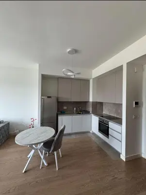 a kitchen with a table and a table and chairs at Beograd na vodi VSLE in Belgrade