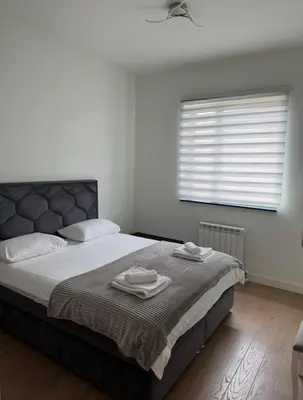 a bedroom with a bed with two towels on it at Beograd na vodi VSLE in Belgrade