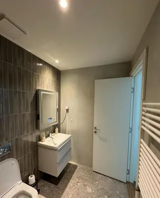 a bathroom with a white sink and a toilet at Beograd na vodi VSLE in Belgrade