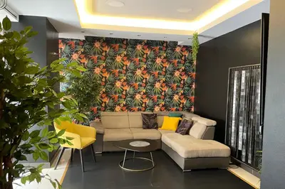 a living room with a couch and a floral wallpaper at Knez in Belgrade