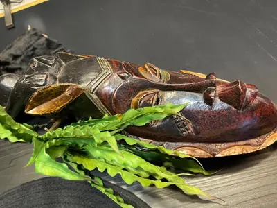 a brown shoe sitting on a table with green leaves at Knez in Belgrade