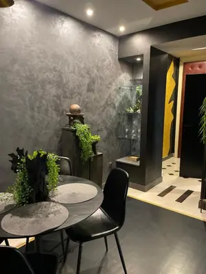 a dining room with two tables and plants on a wall at Knez in Belgrade