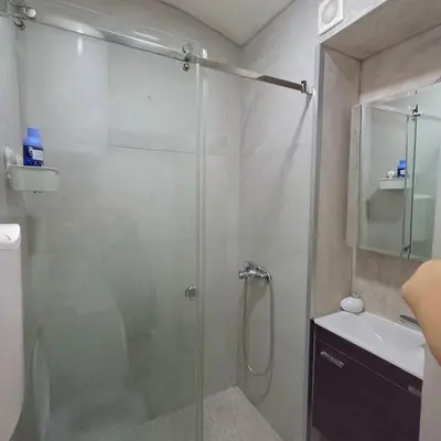 a shower with a glass door in a bathroom at Lela in Belgrade