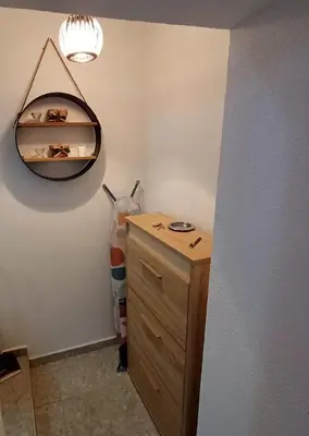 a bathroom with a wooden cabinet and a light at Lela in Belgrade