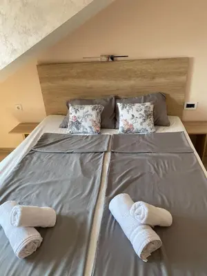 a bed with two towels on top of it at Apartman Masa in Arandjelovac