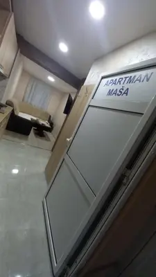 a door in a building with a sign on it at Apartman Masa in Arandjelovac