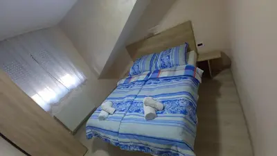 a bed in a small room with towels on it at Apartman Masa in Arandjelovac