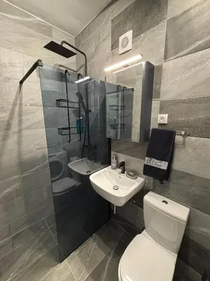 a bathroom with a toilet and a sink and a shower at Urban Yard Retreat in Belgrade