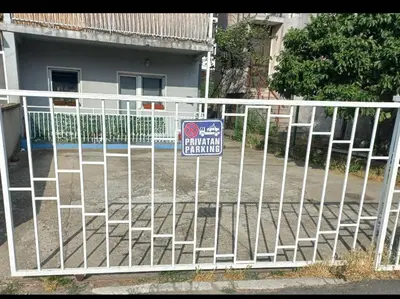 a white fence with a no parking sign on it at Urban Yard Retreat in Belgrade