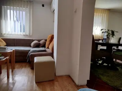 a living room with a couch and a table at Bukuljska kuća in Arandjelovac