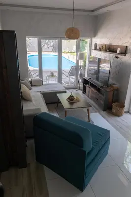 a living room with a couch and a table at Vila Peščana Tišina in Banatski Karlovac