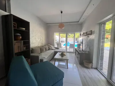 a living room with a couch and a table at Vila Peščana Tišina in Banatski Karlovac