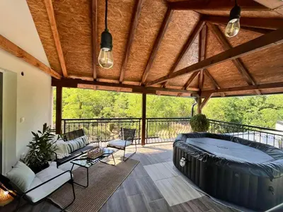 a large room with a large bed on a patio at Vila Peščana Tišina in Banatski Karlovac