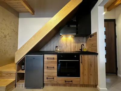 a kitchen with a sink and a stove at Taca House - Airport apartman in Surčin