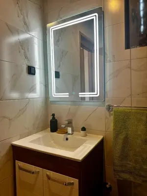 a bathroom with a sink and a mirror at Taca House - Airport apartman in Surčin