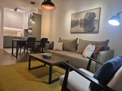 a living room with a couch and a table at Lastavica residence, modern luxury apartment with garage in Novi Beograd