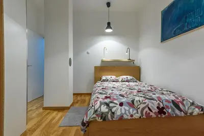 a bedroom with a bed in a white room at Studio 44 in Belgrade