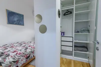 a bedroom with a bed and a closet at Studio 44 in Belgrade