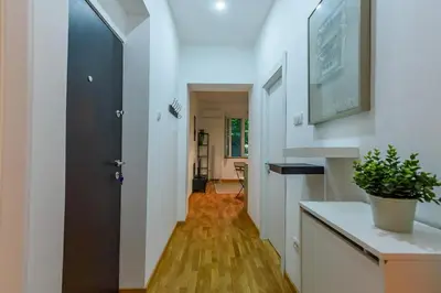 a hallway with white walls and a black door at Studio 44 in Belgrade