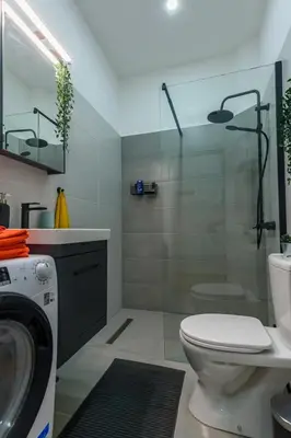 a bathroom with a toilet and a glass shower at Studio 44 in Belgrade
