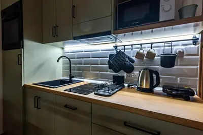 a kitchen with a sink and a stove top oven at Studio 44 in Belgrade