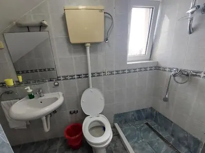 a bathroom with a toilet and a sink at Maja Rooms & Garden in Smederevo