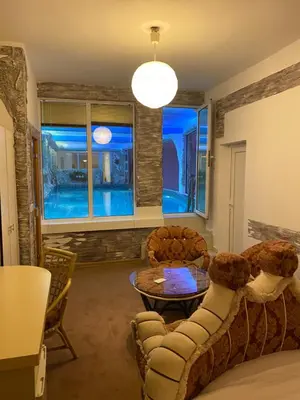 a living room with a couch and a table at Bali Colosseum Hotel in Belgrade