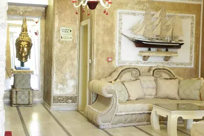 a living room with a couch and a boat on the wall at Bali Colosseum Hotel in Belgrade