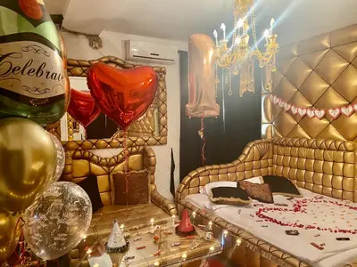 a room with a bed with balloons and a champagne bottle at Bali Colosseum Hotel in Belgrade