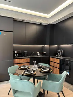 a dining room with a table and chairs and a kitchen at Elegant 2BR BW Apartment 2 Bathrooms -Private Garage A1 Residence Bw in Belgrade