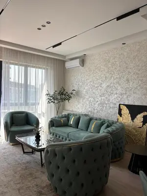 a living room with a green couch and a table at Elegant 2BR BW Apartment 2 Bathrooms -Private Garage A1 Residence Bw in Belgrade