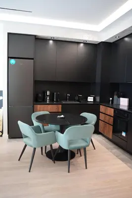 a kitchen with a table and chairs in a room at Elegant 2BR BW Apartment 2 Bathrooms -Private Garage A1 Residence Bw in Belgrade