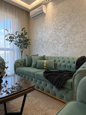 a living room with a blue couch and a table at Elegant 2BR BW Apartment 2 Bathrooms -Private Garage A1 Residence Bw in Belgrade