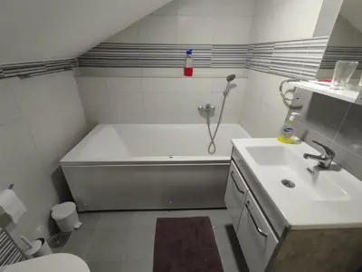a bathroom with a bath tub and a sink at Miran San Apartment Belgrade in Mali Mokri Lug