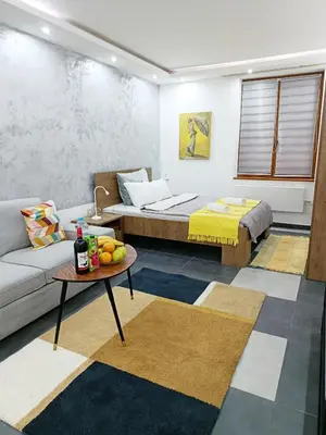 a living room with a couch and a table at Urban Garden Apartments - Iris in Belgrade