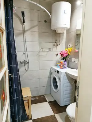 a bathroom with a washing machine and a sink at Urban Garden Apartments - Iris in Belgrade