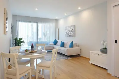 a living room with a table and a couch at New Luxury Dorcol Downtown Apartment in Belgrade