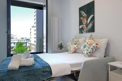 a large bed in a room with a large window at New Luxury Dorcol Downtown Apartment in Belgrade