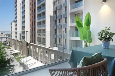 a table on a balcony with a view of a building at New Luxury Dorcol Downtown Apartment in Belgrade