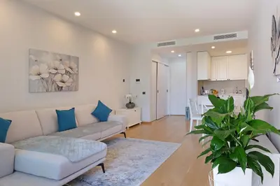 a living room with a couch and a kitchen at New Luxury Dorcol Downtown Apartment in Belgrade