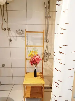 a vase of flowers on a table in a bathroom at Urban Garden Apartments - Sunflower in Belgrade