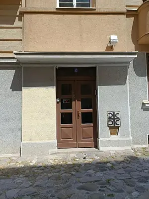 a building with a brown door with a sign on it at Urban Garden Apartments - Sunflower in Belgrade