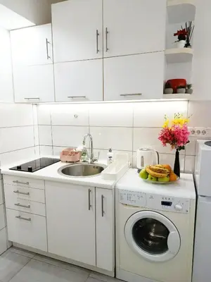 a white kitchen with a sink and a washing machine at Urban Garden Apartments - Sunflower in Belgrade