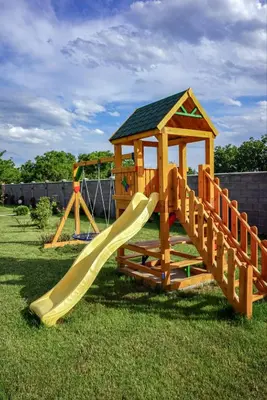 a wooden playground with a slide and a gazebo at Vila Gospođica in Progar