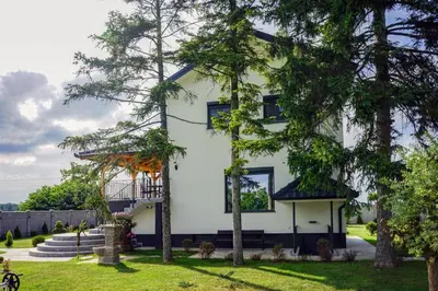 a white house with trees in front of it at Vila Gospođica in Progar