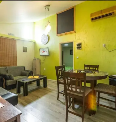 a living room with a couch and a table at Eko dan in Železnička Stanica Karlovački Vinogradi