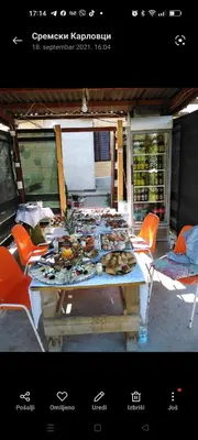 a picnic table with food on it with orange chairs at Eko dan in Železnička Stanica Karlovački Vinogradi