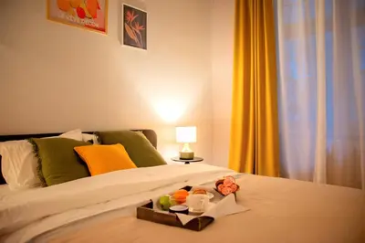 a bedroom with a bed with a tray of fruit on it at Ollio Quiet City Center Apartments in Belgrade