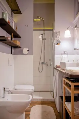a bathroom with a shower and a toilet and a sink at Ollio Quiet City Center Apartments in Belgrade