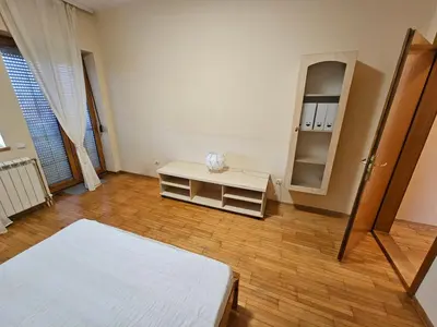 a bedroom with a bed and a dresser and a mirror at Zora apartment in Belgrade